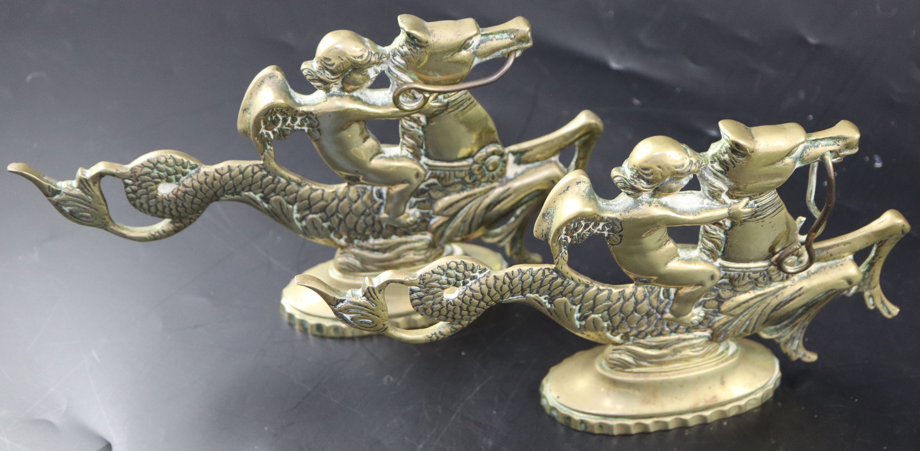 A pair of Venetian brass door stops, width 25cm height 15.5cm